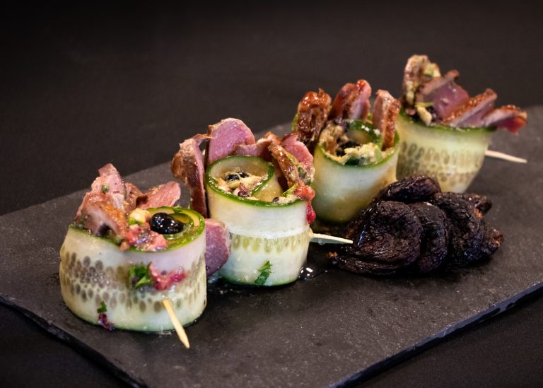 Smoked duck breast in a cucumber roulade, avocado and wild berries